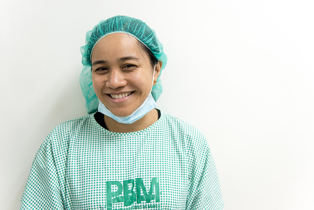 Kimmy Coseteng-Flaviano smiling in PBM scrubs