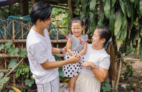 Kaylee smiling and hugging her parents Ken and Selma after cleft surgery