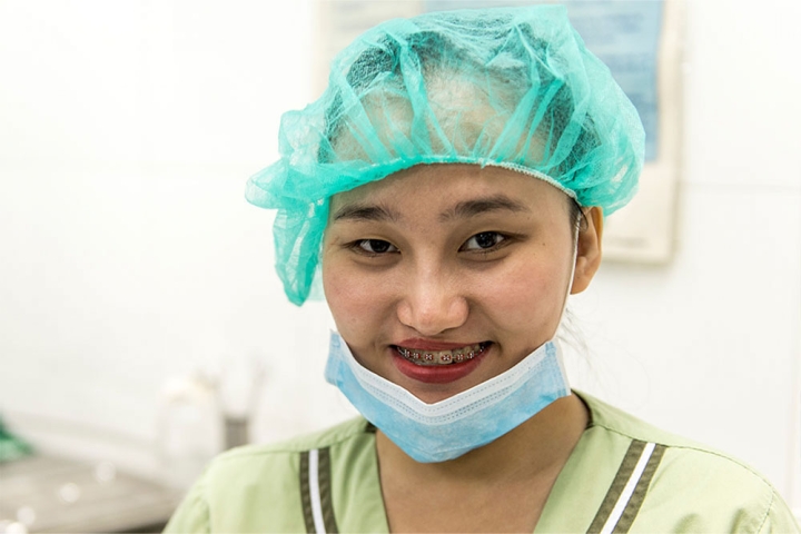 Gracee smiling in nurse scrubs