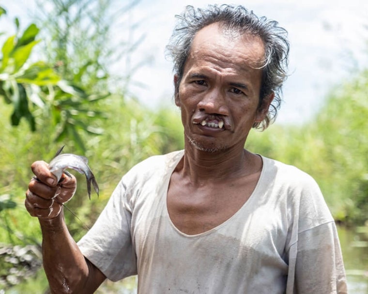 Alim holding a fish